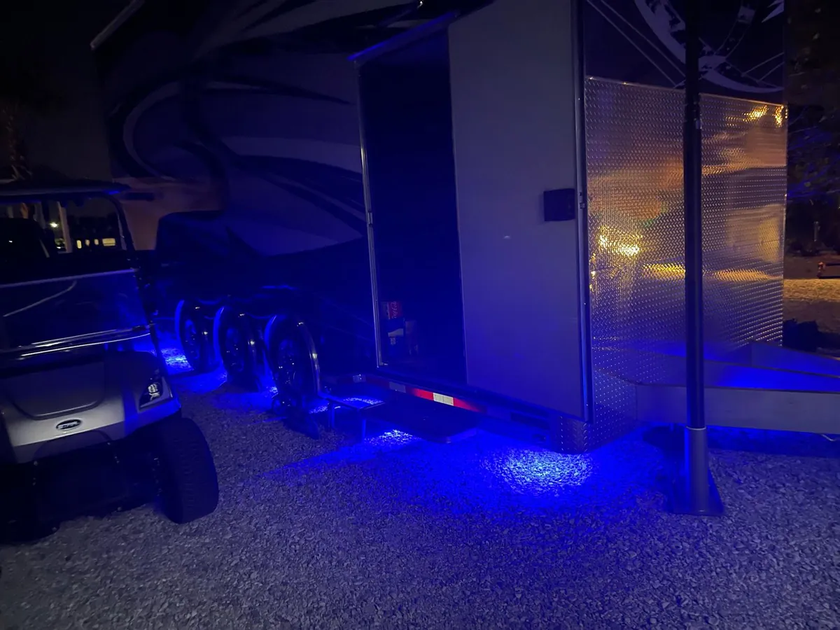 Enclosed hauler and golf cart with blue underglow